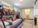 Cozy bedroom with bunk beds, adjacent bath, and laminate wood-look flooring at 219 E Fern Dr, Orange City, FL 32763