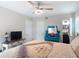 Comfortable bedroom with ceiling fan, laminate wood flooring and natural light at 219 E Fern Dr, Orange City, FL 32763