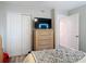 This bedroom features a closet, a neutral color scheme, a television, and a cozy atmosphere at 219 E Fern Dr, Orange City, FL 32763