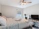 Comfortable bedroom with ceiling fan, laminate wood flooring and natural light at 219 E Fern Dr, Orange City, FL 32763