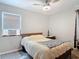 This bedroom features a ceiling fan, a neutral color scheme, and a cozy atmosphere at 219 E Fern Dr, Orange City, FL 32763