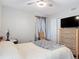This bedroom features a ceiling fan, a neutral color scheme, and a cozy atmosphere at 219 E Fern Dr, Orange City, FL 32763
