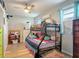 Colorful room with bunk beds, ceiling fan and laminate wood floors at 219 E Fern Dr, Orange City, FL 32763