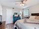 Comfortable bedroom with ceiling fan, laminate wood flooring and natural light at 219 E Fern Dr, Orange City, FL 32763