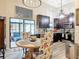 Charming dining area with a round table, floral chairs, and a view into the kitchen at 219 E Fern Dr, Orange City, FL 32763