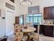 Bright dining room features wood floors, chandelier, and table with decorative chairs at 219 E Fern Dr, Orange City, FL 32763