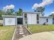 Charming single-story home featuring a unique modern design and well-maintained front yard at 219 E Fern Dr, Orange City, FL 32763