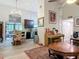 Open-concept living area with an elegant chandelier, dining space, and stylish decor at 219 E Fern Dr, Orange City, FL 32763