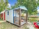 The backyard features a blue and white shed with front porch and room for storage at 219 E Fern Dr, Orange City, FL 32763