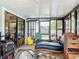 Enclosed sunroom has black framed windows with sliding glass doors and a ceiling fan at 219 E Fern Dr, Orange City, FL 32763