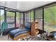 Enclosed sunroom features black framed windows, a lounge chair and storage cabinet at 219 E Fern Dr, Orange City, FL 32763