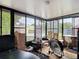 Enclosed sunroom features black framed windows offering views of backyard, pool and garden shed at 219 E Fern Dr, Orange City, FL 32763