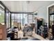 This cozy enclosed sunroom has black framed windows providing natural light and air flow at 219 E Fern Dr, Orange City, FL 32763