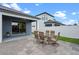 Spacious outdoor patio with a dining set leading to a sliding glass door at 2210 Romanum Dr, Winter Garden, FL 34787