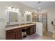 Primary bathroom featuring double sinks, granite countertops, and a glass-enclosed shower at 2210 Romanum Dr, Winter Garden, FL 34787