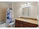 Well-lit bathroom featuring granite countertops and a shower-tub combo at 2210 Romanum Dr, Winter Garden, FL 34787