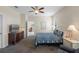 Inviting bedroom with carpet flooring, a ceiling fan, and ample natural light at 2210 Romanum Dr, Winter Garden, FL 34787