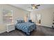 Cozy bedroom with a ceiling fan, natural light, and a connecting bathroom at 2210 Romanum Dr, Winter Garden, FL 34787