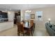 Open concept dining area with wood table and chair set next to the well-equipped kitchen at 2210 Romanum Dr, Winter Garden, FL 34787