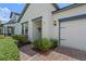 Welcoming home featuring a brick pathway, neatly trimmed bushes, and an attached two-car garage at 2210 Romanum Dr, Winter Garden, FL 34787