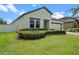 Well-maintained home with green lawn and manicured landscaping around the entrance and windows at 2210 Romanum Dr, Winter Garden, FL 34787
