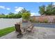 Charming outdoor patio with table, chairs, brick planter, and privacy fence at 2210 Romanum Dr, Winter Garden, FL 34787