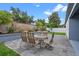 Charming outdoor patio with table, chairs, brick planter, and privacy fence at 2210 Romanum Dr, Winter Garden, FL 34787