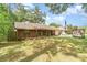 Brick home with green lawn, tree, and a rented storage unit in the driveway at 236 Longhorn Dr, Apopka, FL 32712