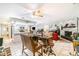 Open concept living area featuring a brick fireplace, ceiling fan, and tile flooring throughout at 236 Longhorn Dr, Apopka, FL 32712