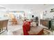 Bright living room featuring tile flooring, a red sofa, and seamless flow to kitchen at 236 Longhorn Dr, Apopka, FL 32712