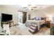 Bedroom with a sliding barn door to the ensuite bathroom and carpet floors at 236 Longhorn Dr, Apopka, FL 32712