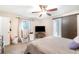 Bedroom with carpet floors and a sliding barn door to the ensuite bathroom at 236 Longhorn Dr, Apopka, FL 32712