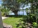Tranquil backyard with a lake view and swing, perfect for relaxation and enjoying nature from home at 2421 Queenswood Cir, Kissimmee, FL 34743