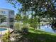 Lake view with lush greenery, partially obscured by screen enclosure, offering a private and scenic outdoor retreat at 2421 Queenswood Cir, Kissimmee, FL 34743