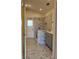 Updated bathroom with marble tile, gray vanity, and walk-in shower at 2421 Queenswood Cir, Kissimmee, FL 34743