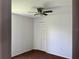 Bedroom with carpeted floors and closet with ceiling fan at 2421 Queenswood Cir, Kissimmee, FL 34743