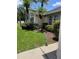 Well-manicured front yard with mature plants and mulch beds at 2421 Queenswood Cir, Kissimmee, FL 34743