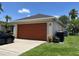 Side view of the two car garage and long driveway at 2421 Queenswood Cir, Kissimmee, FL 34743