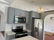 Well-equipped kitchen boasts stainless steel appliances, modern cabinetry, and quartz countertops at 2421 Queenswood Cir, Kissimmee, FL 34743