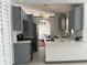 An open kitchen features modern cabinets, quartz countertops, and stainless steel appliances at 2421 Queenswood Cir, Kissimmee, FL 34743