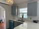 Modern kitchen featuring quartz countertops, blue cabinets, and stainless steel appliances at 2421 Queenswood Cir, Kissimmee, FL 34743