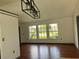 Open living room with hardwood floors and large windows at 2421 Queenswood Cir, Kissimmee, FL 34743