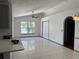 Bright living room featuring tile flooring, a ceiling fan, and a large window showcasing picturesque water views at 2421 Queenswood Cir, Kissimmee, FL 34743
