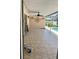 Covered patio featuring tiled flooring, ceiling fan, exterior access to a pool, and decorative wall art at 2421 Queenswood Cir, Kissimmee, FL 34743