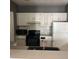 View of the kitchen with white cabinets, gray walls and stainless appliances at 2525 Maitland Crossing Way # 202, Orlando, FL 32810