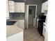 Open-concept kitchen with white cabinets, black sink, tiled backsplash, and tile floors at 2525 Maitland Crossing Way # 202, Orlando, FL 32810