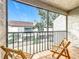 Enjoy the view from this cozy balcony with tile floor and wooden folding chairs at 260 Killarney Bay Ct # 6-6, Winter Park, FL 32789