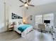 Cozy bedroom with a ceiling fan, a large window, and a desk, offering a comfortable and functional space at 260 Killarney Bay Ct # 6-6, Winter Park, FL 32789