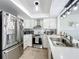 Kitchen featuring stainless steel appliances, bright white cabinets, and a modern range hood at 260 Killarney Bay Ct # 6-6, Winter Park, FL 32789