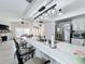 Bright kitchen features a large island with a white countertop, stainless steel appliances, and modern light fixtures at 260 Killarney Bay Ct # 6-6, Winter Park, FL 32789
